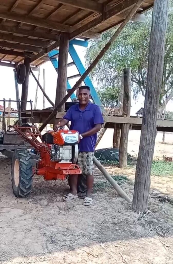 Pastor Kein shows off their new-to-them walk-behind tractor and plow.